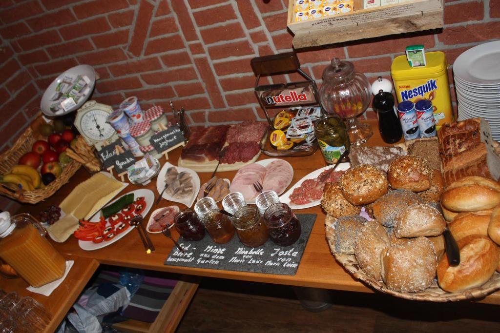 a table topped with lots of different types of bread at Armarova Ihre Ferienpension in Cuxhaven