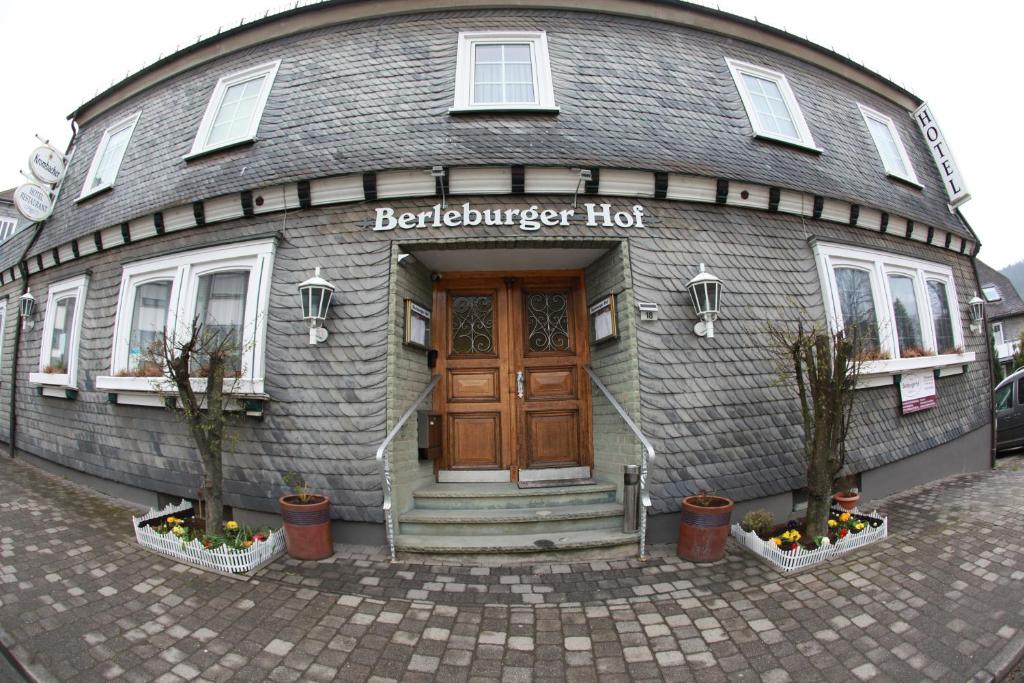 un edificio con puerta de madera y porche en Berleburger Hof, en Bad Berleburg