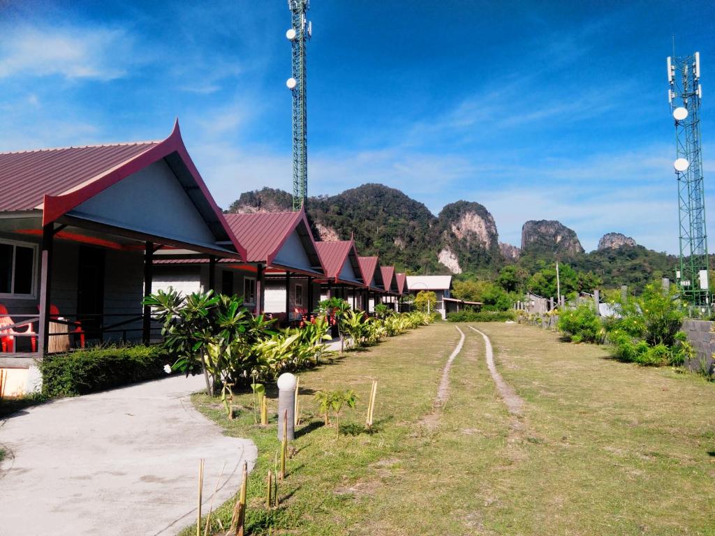 a row of buildings with mountains in the background at Phi Phi Coralbay in Phi Phi Islands