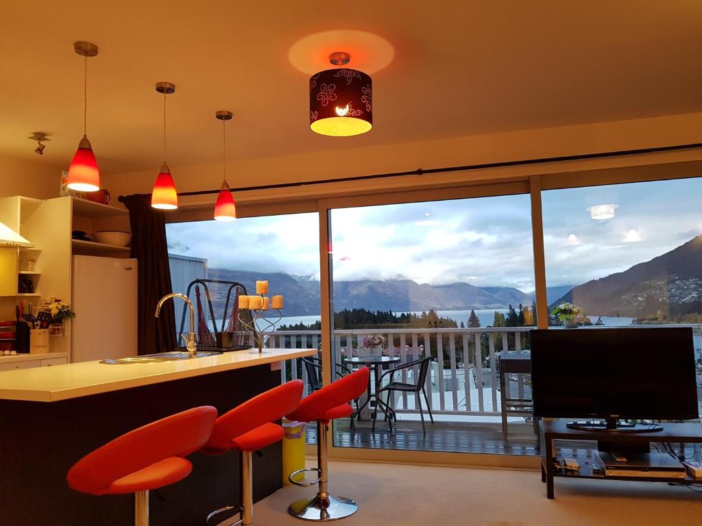 a kitchen with a large window with a view of the mountains at With amazing rooftop-Central Lakeview 3bedrooms Apartments镇上湖景三室套房 in Queenstown