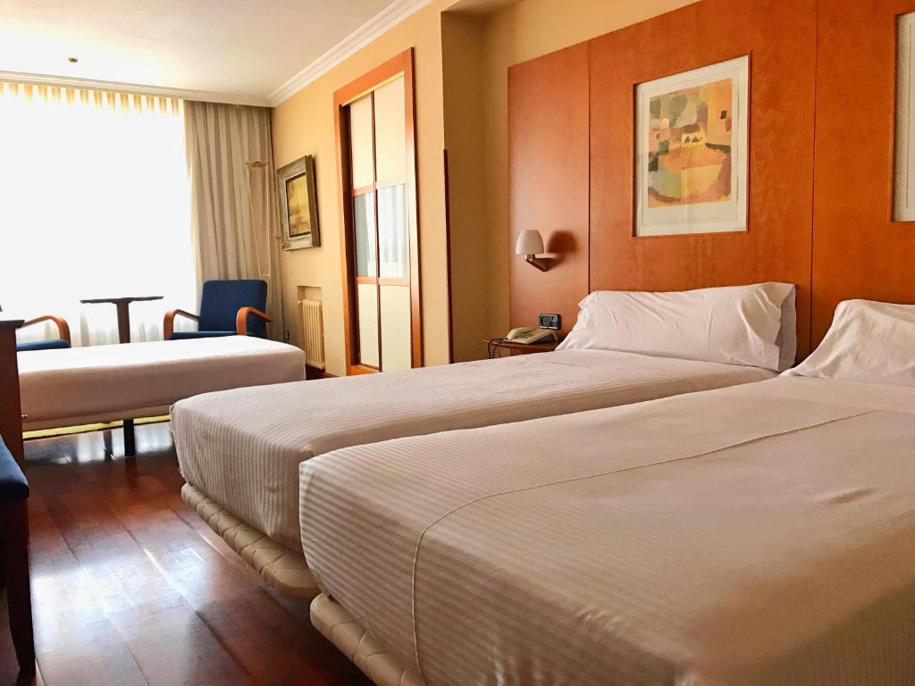 Postel nebo postele na pokoji v ubytování Hotel Gran Regente