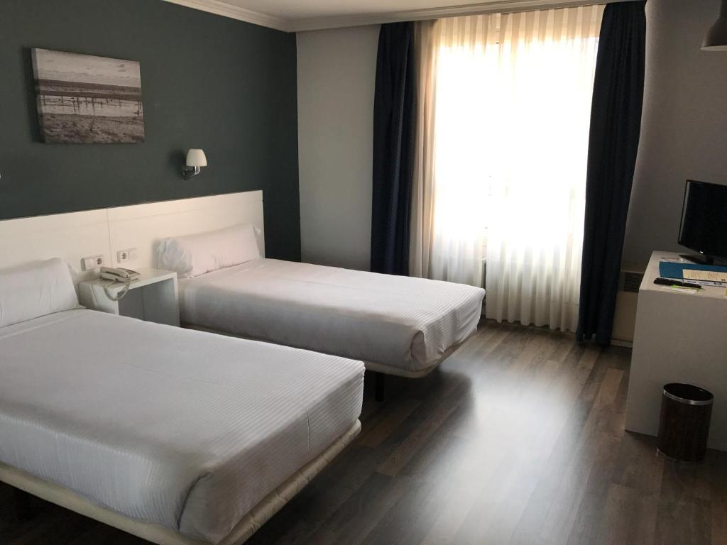 Postel nebo postele na pokoji v ubytování Hotel Gran Regente