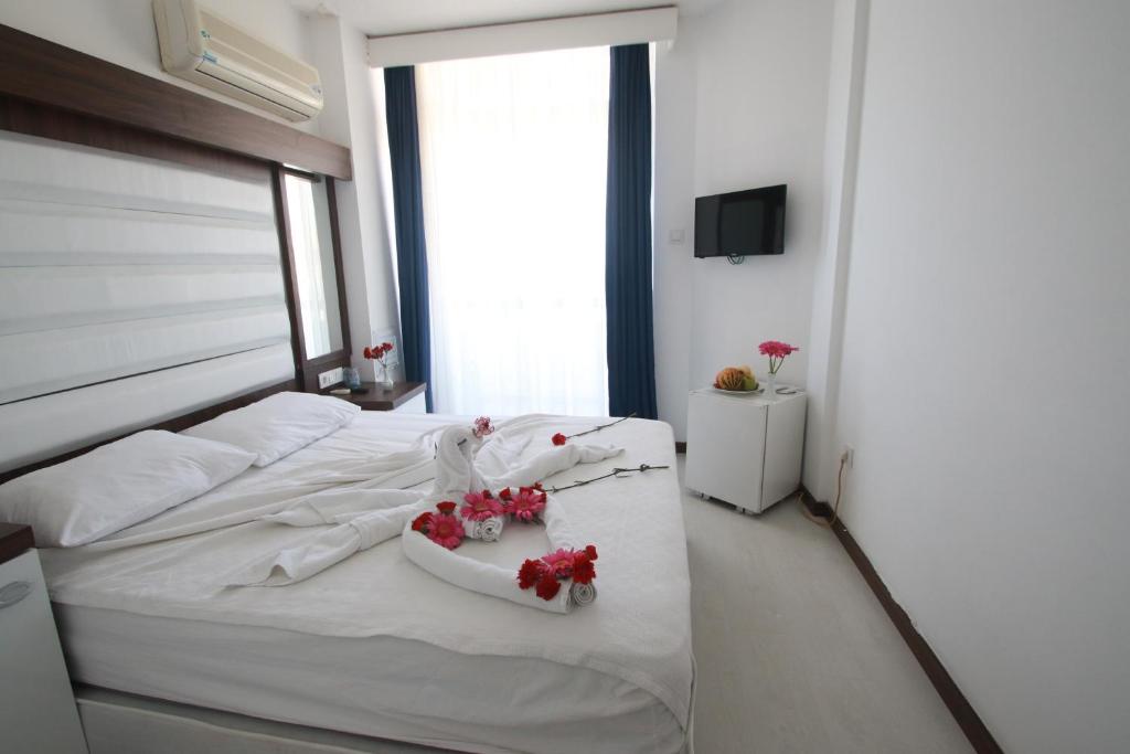 Ein Bett oder Betten in einem Zimmer der Unterkunft Asena Hotel