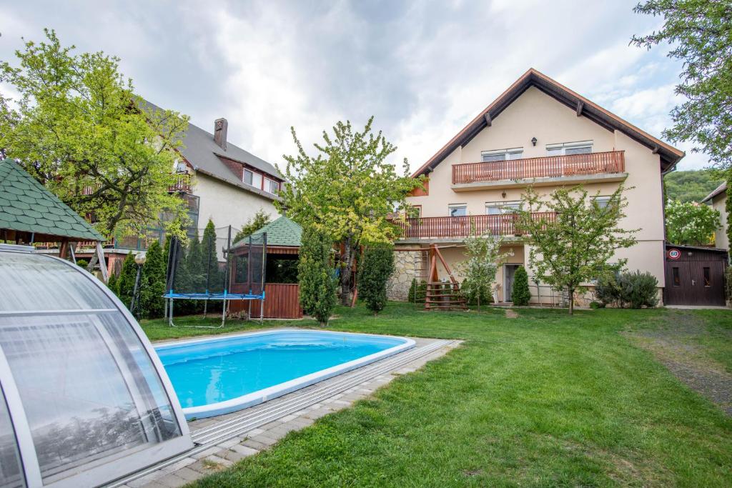 an exterior view of a house with a swimming pool at Sándor Apartman in Balatonfüred