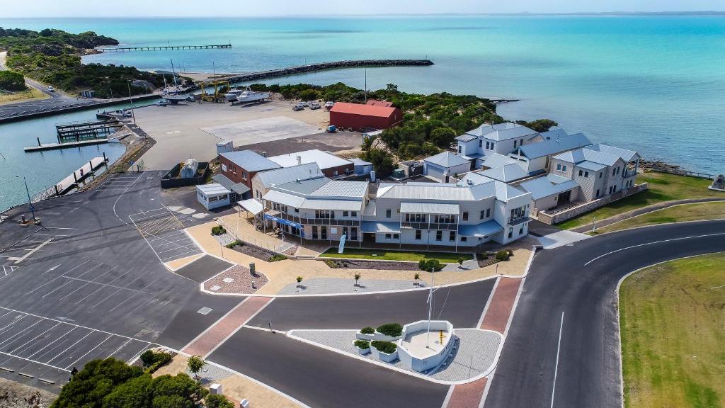 an aerial view of a large house next to the ocean at Robe Marina Accommodation in Robe