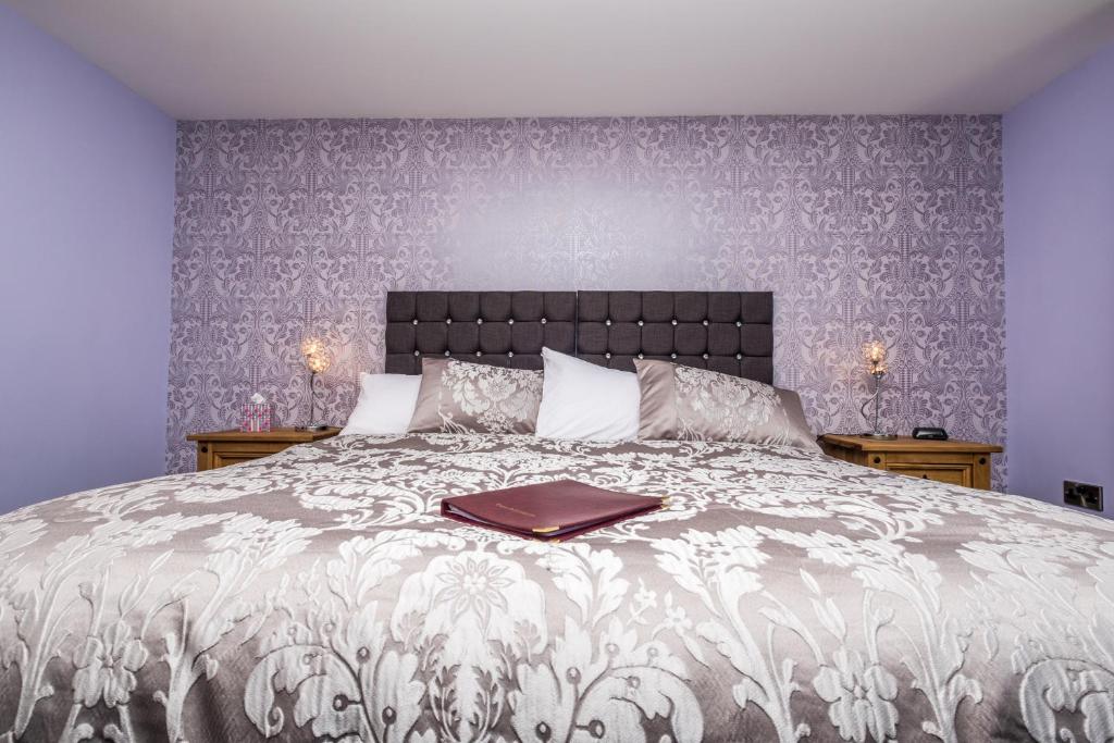 a bedroom with a bed with a book on it at Lazy Days in Whitby