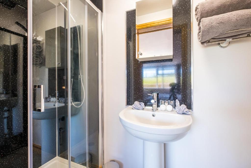 a bathroom with a sink and a shower at Lazy Days in Whitby