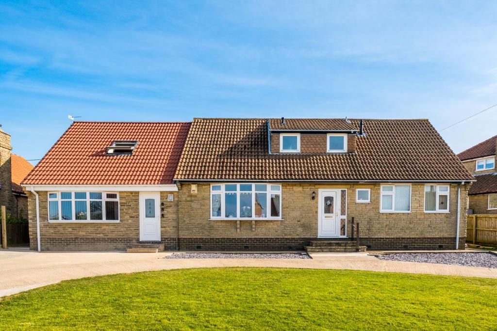 a brick house with a red roof at Lazy Days in Whitby