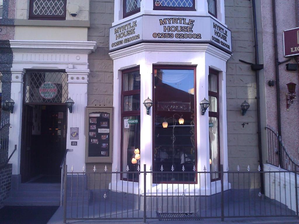 a store front of a building with a window at Myrtle house in Blackpool