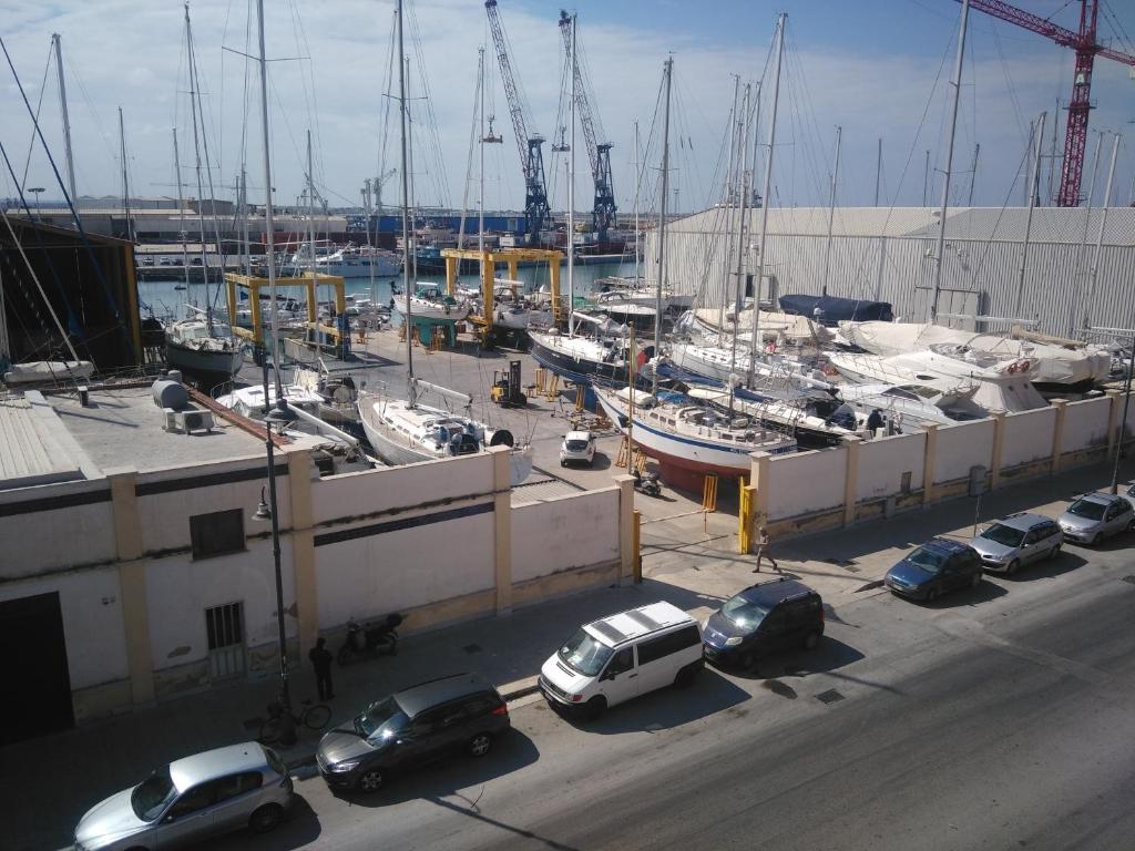 a group of cars parked at a marina with boats at L'Oasi del Porto in Trapani