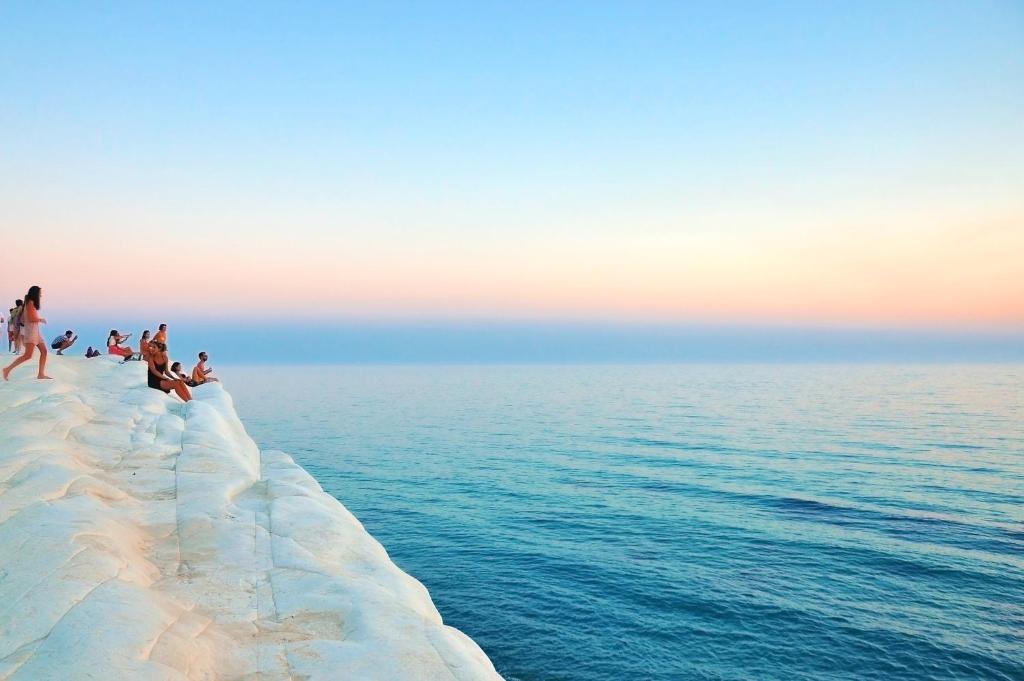 a group of people sitting on top of a snow covered iceberg at Marnabianca Apartment in Realmonte