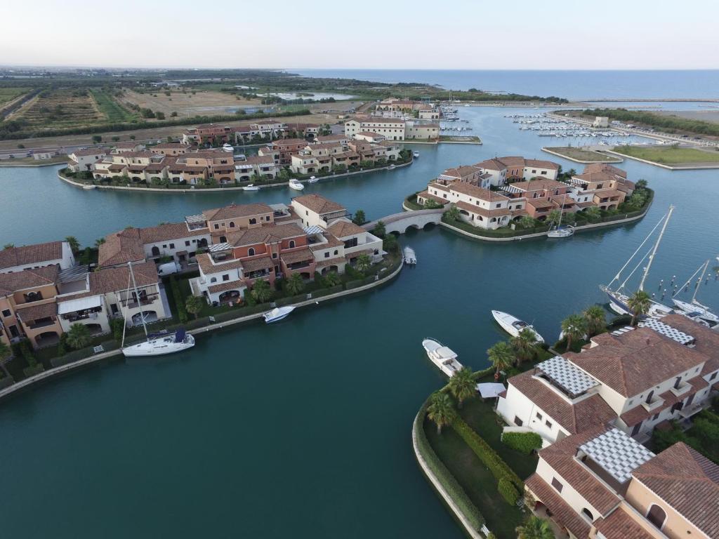 an aerial view of a harbor with houses and boats at Marinagri Resort in Policoro