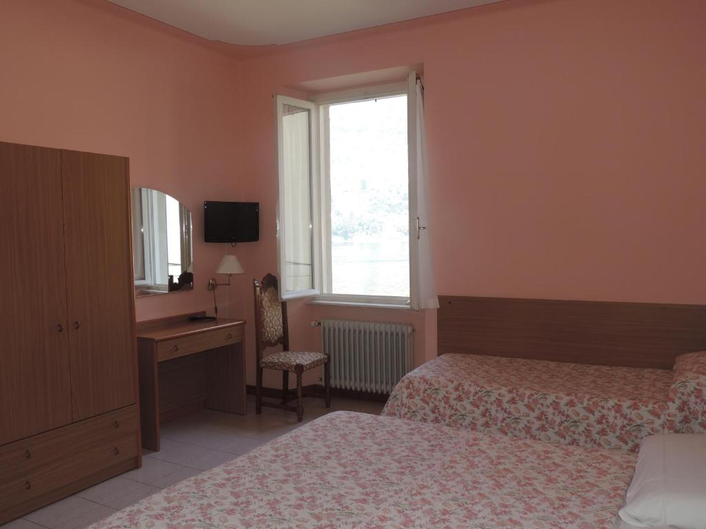 Postel nebo postele na pokoji v ubytování Hotel Vapore