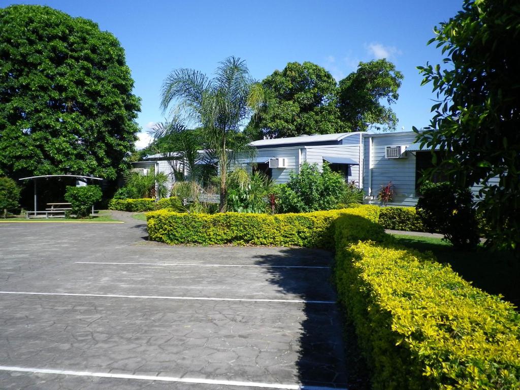 a parking lot in front of a house at Tin Can Bay's Sleepy Lagoon Motel in Tin Can Bay
