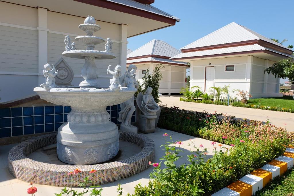 a fountain in front of a house at Bualuang Boutique Resort in Ang Thong