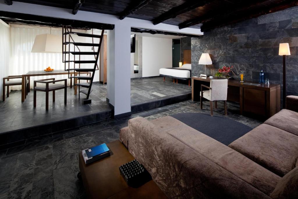 a living room with a couch and a table at Hotel Boutique Ses Pitreras in San Antonio Bay