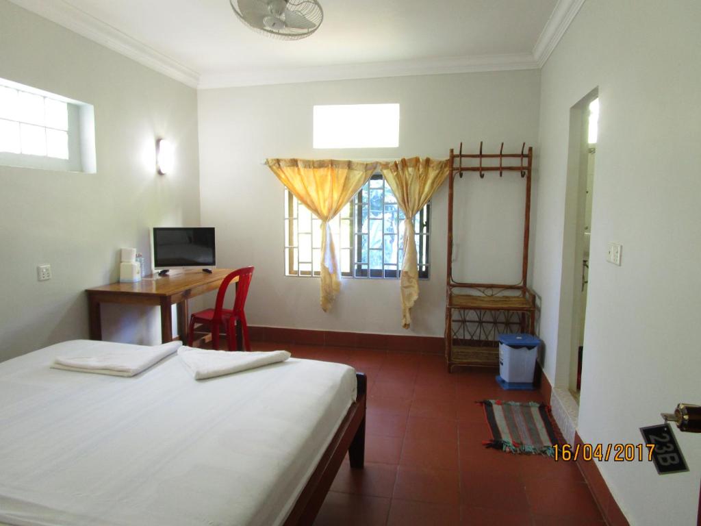 Postel nebo postele na pokoji v ubytování Visal Sak Guesthouse