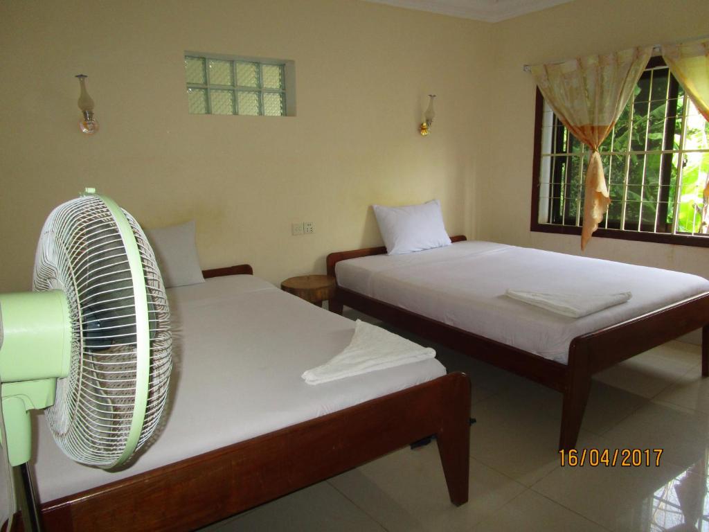 Postel nebo postele na pokoji v ubytování Visal Sak Guesthouse