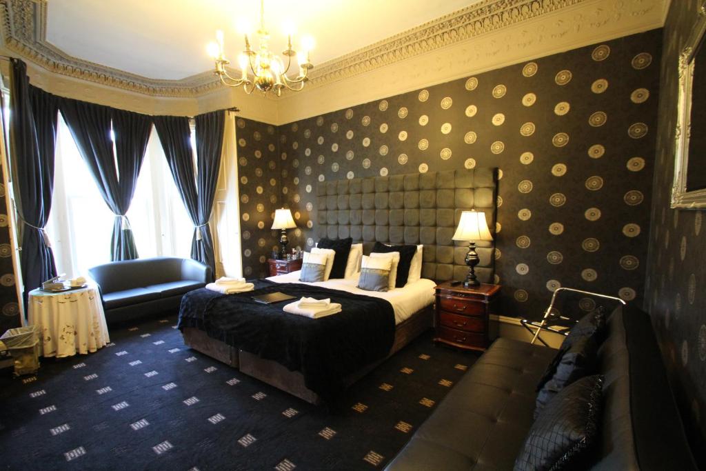 a hotel room with a large bed and a large mirror at The Sandaig in Edinburgh