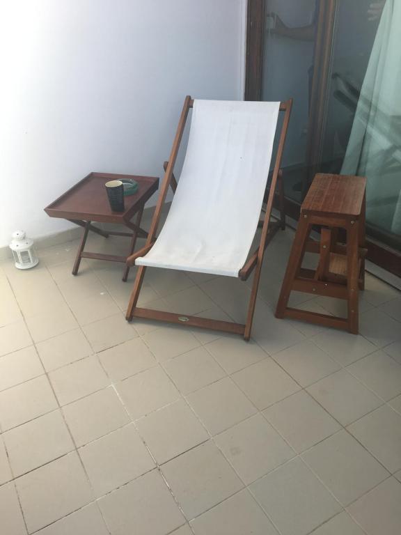 a wooden easel with a white canvas next to a table at Monte Gordo Flat in Monte Gordo