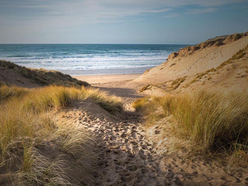 a sandy path leading to the ocean on a beach at EsJays at Knowles House in Lytham St Annes