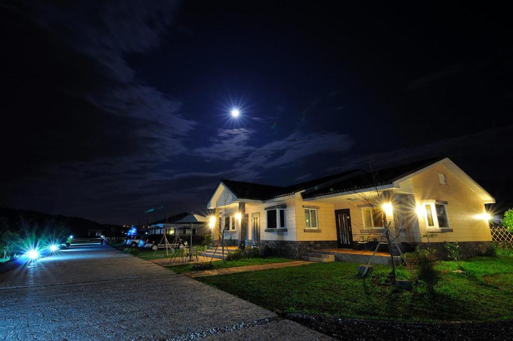a house at night with the moon in the sky at Countryside B&amp;B in Ruisui
