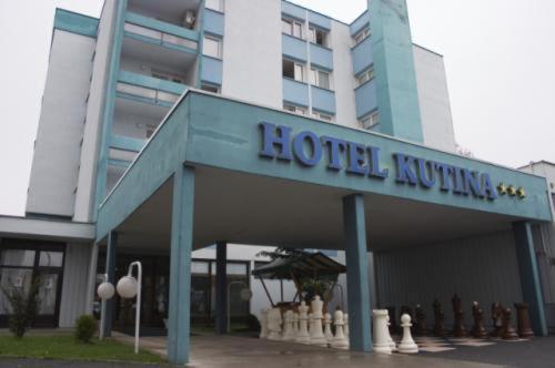 a hotel building with a sign in front of it at Hotel Kutina in Kutina