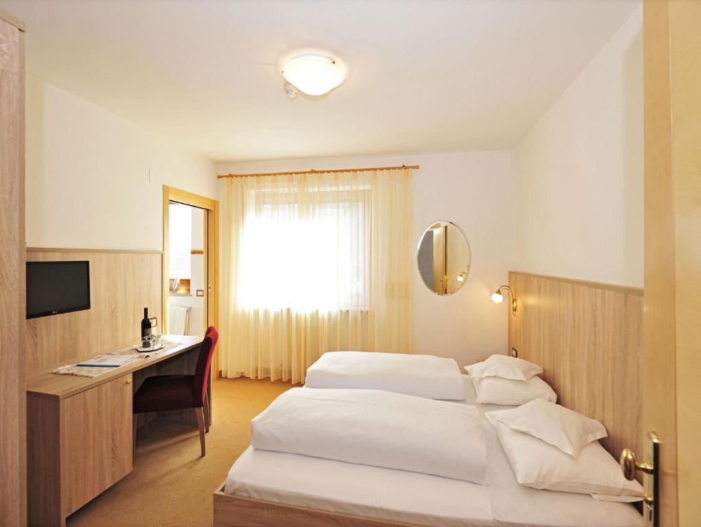 Posteľ alebo postele v izbe v ubytovaní Hotel-Garni Appartement Gartenheim