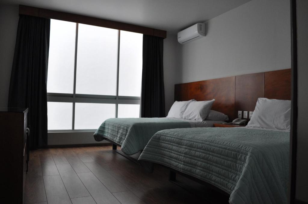 Postel nebo postele na pokoji v ubytování AMD Hotel
