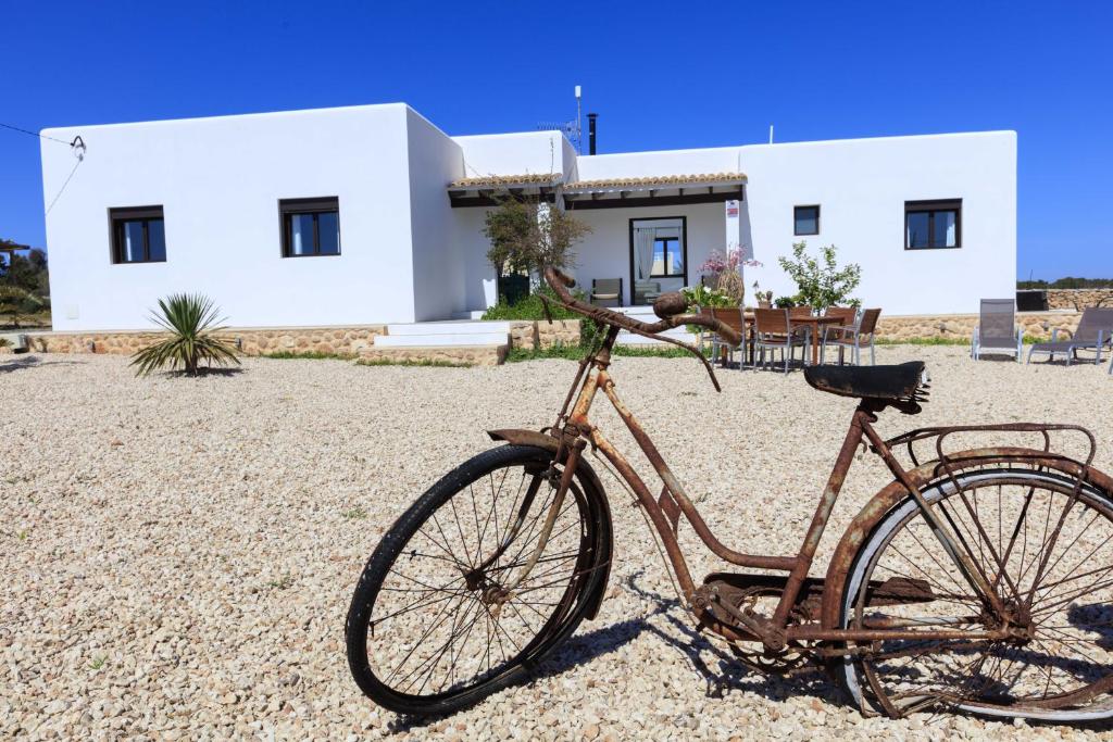 a bike parked in front of a house at Can Coques in Sant Francesc Xavier