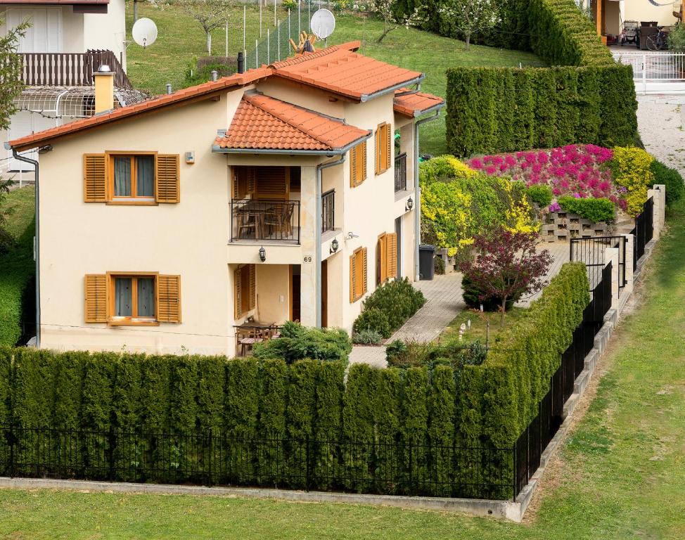 a house is seen through a hedge at Mediterran Apartman in Zalakaros