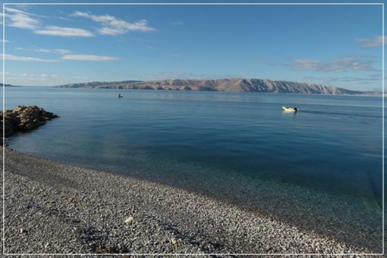 a boat in a large body of water at Apartment Rafael in Senj