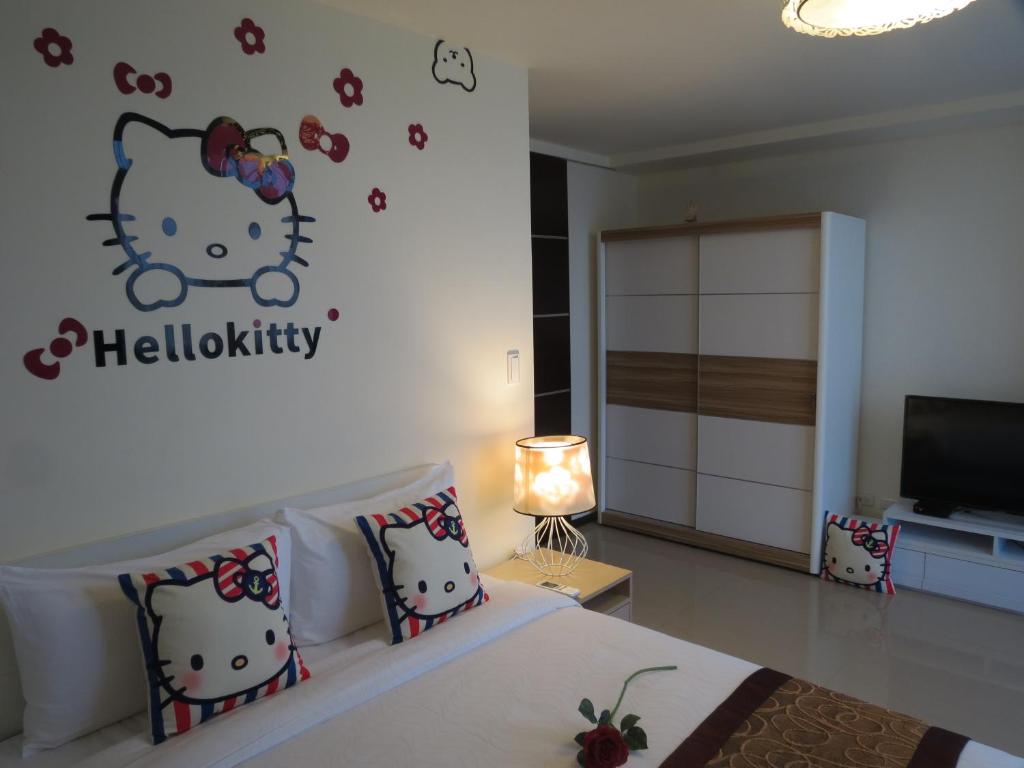 a bedroom with a bed with a hello kitty sticker on the wall at Grand Allevia Villa in Wujie