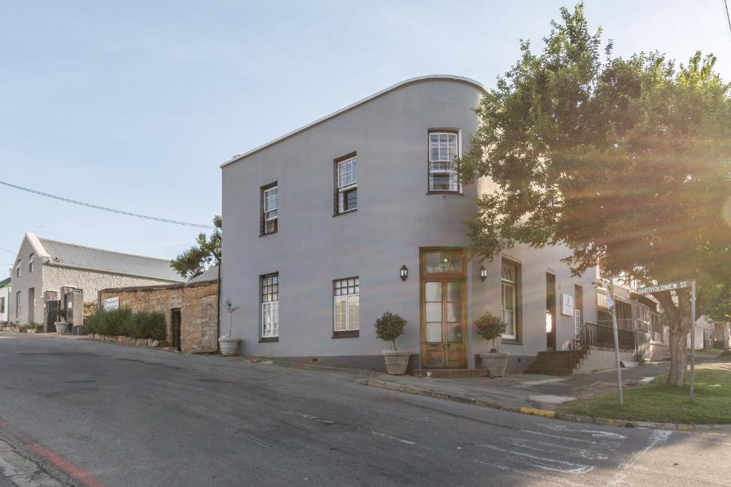 a white building on the side of a street at Bartholomew's Loft in Grahamstown