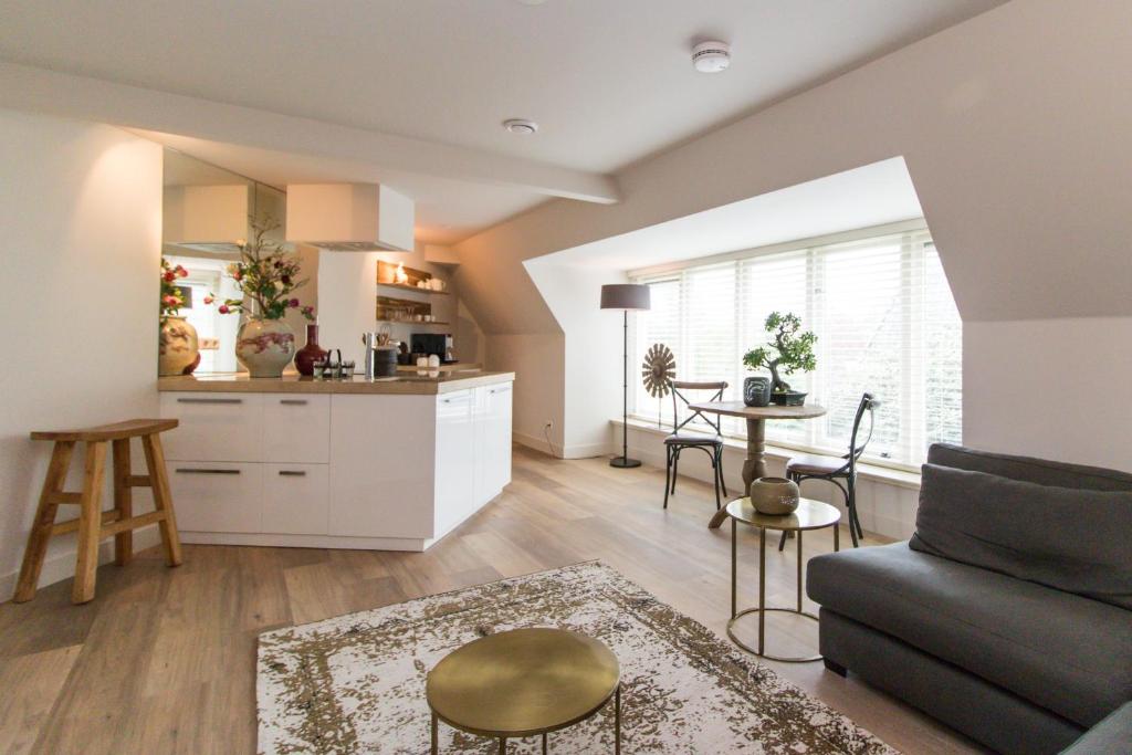 a kitchen and living room with a couch and a table at Short stay Midden Drenthe in Beilen