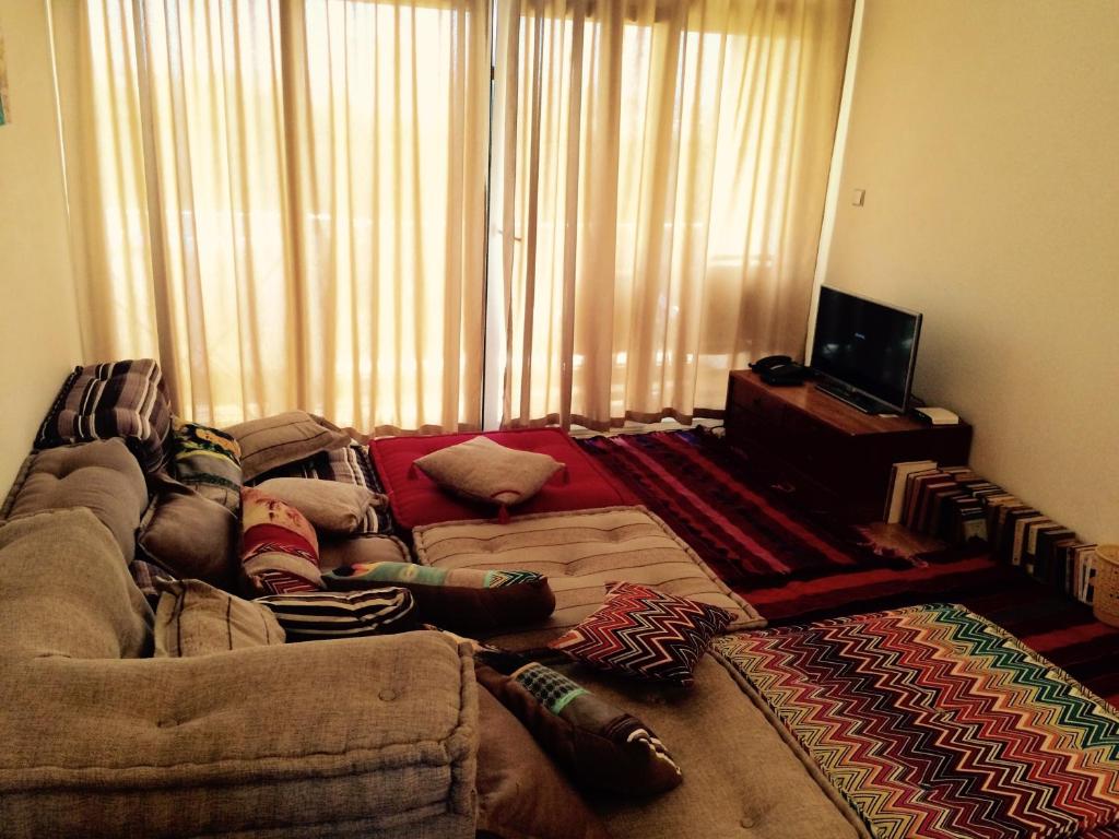 a living room with a couch and a television at CosyFlat 10minBeach in Agadir