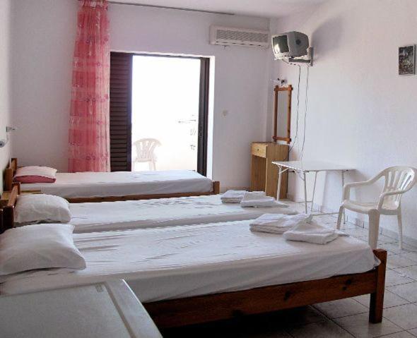 Postel nebo postele na pokoji v ubytování Skentos Hotel
