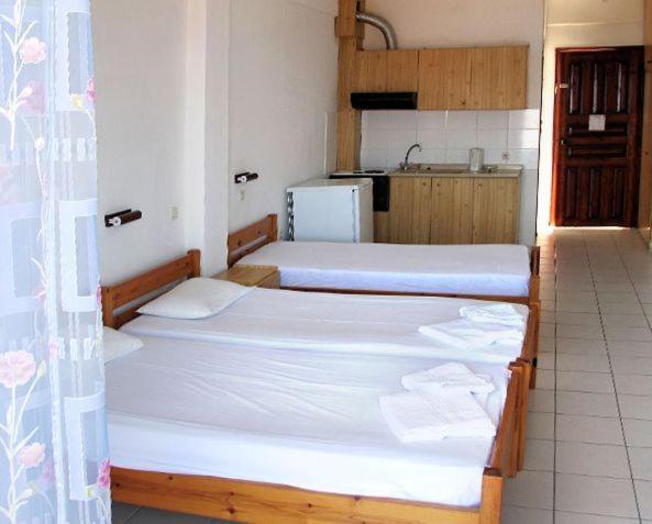 Postel nebo postele na pokoji v ubytování Skentos Hotel