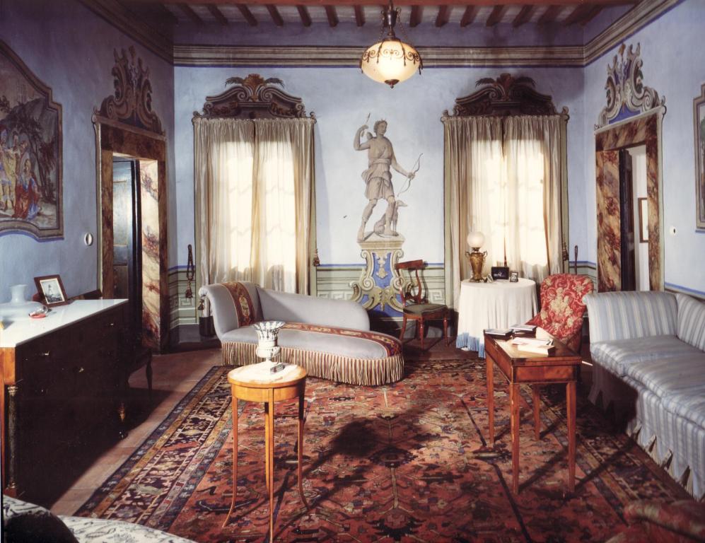 a living room with couches and a statue on the wall at Villa Del Rimedio in Fucecchio