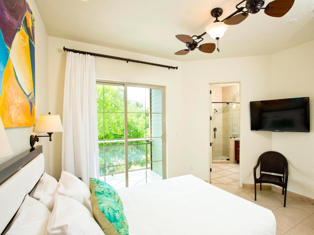 a bedroom with a bed and a flat screen tv at The Resort at Schlitterbahn in New Braunfels