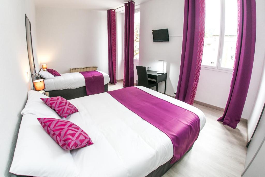 two beds in a hotel room with purple curtains at Grand Hotel De France in Meyrueis