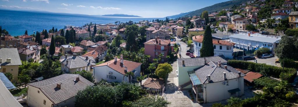 an aerial view of a town with houses and the ocean at Apartments Kinkela in Opatija
