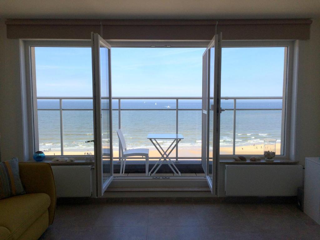 a living room with a view of the ocean at appartement seafront in Ostend