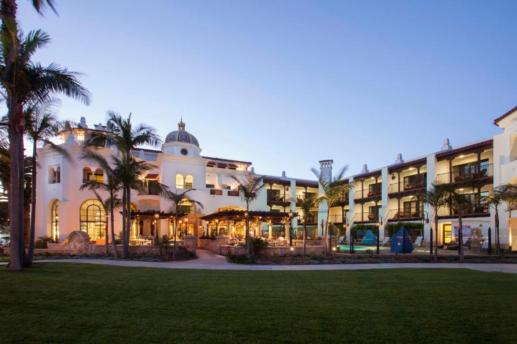 a large building with palm trees in front of it at Santa Barbara Inn in Santa Barbara
