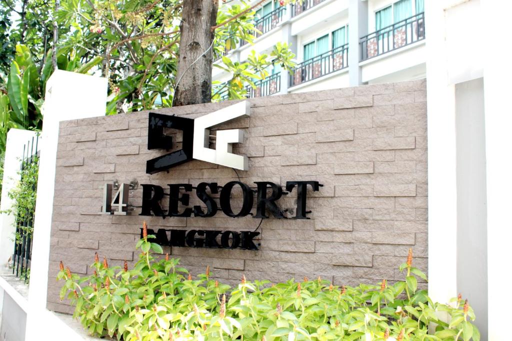 a sign for the resort lobby in front of a building at 14 Resort in Bangkok