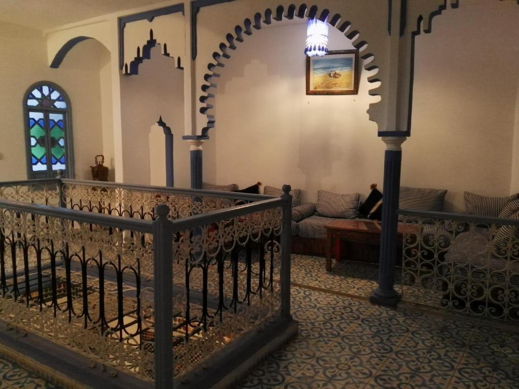 a wrought iron fence in a room with a couch at Hotel Ouarzazate in Chefchaouene