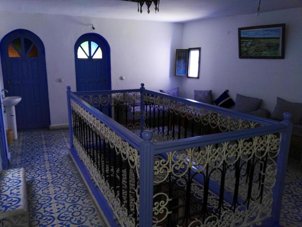 a room with two blue doors and a staircase at Hotel Ouarzazate in Chefchaouene