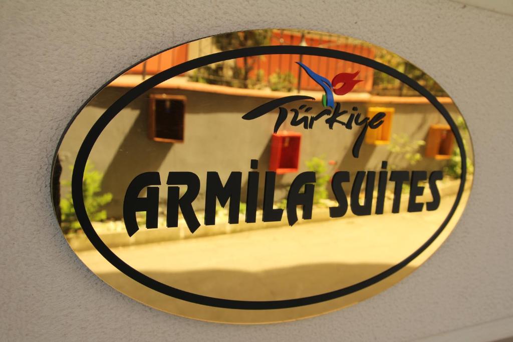 a mirror on a wall with a sign on it at New Armila Suites in Trabzon