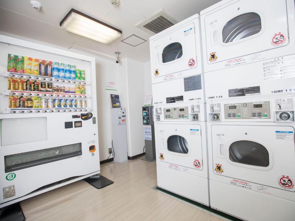a row of white washers and dryers in a store at FLEXSTAY INN Shinagawa in Tokyo