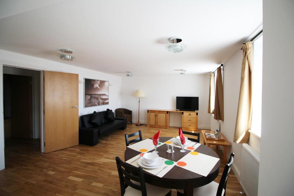 a living room with a table and a couch at Wellesley Road Apartments in Croydon